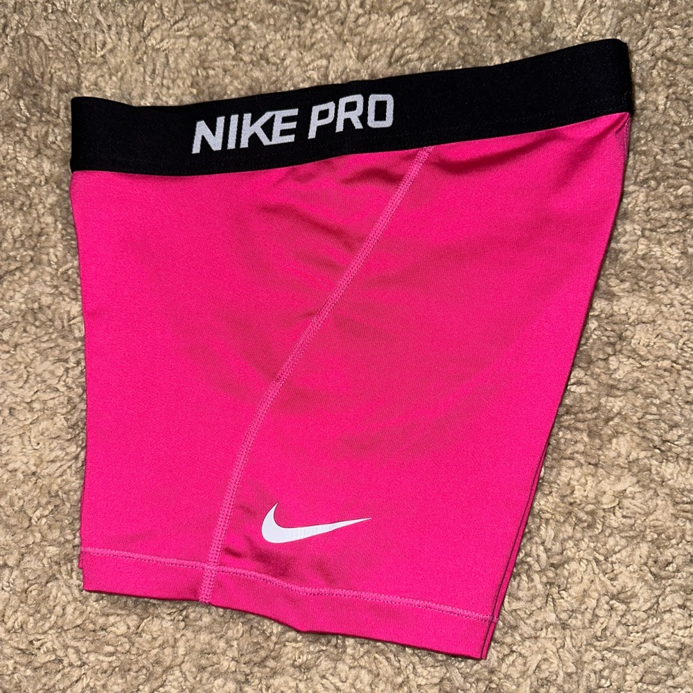 Pink with black waistband Nike pros. Good condition. Old style.